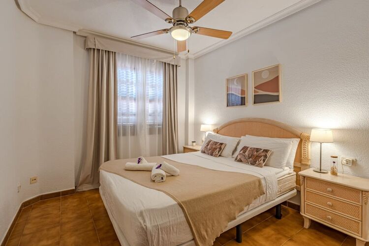 Bedroom with Queen-Bed, Wardrobe, Ceiling Fan & Pool View