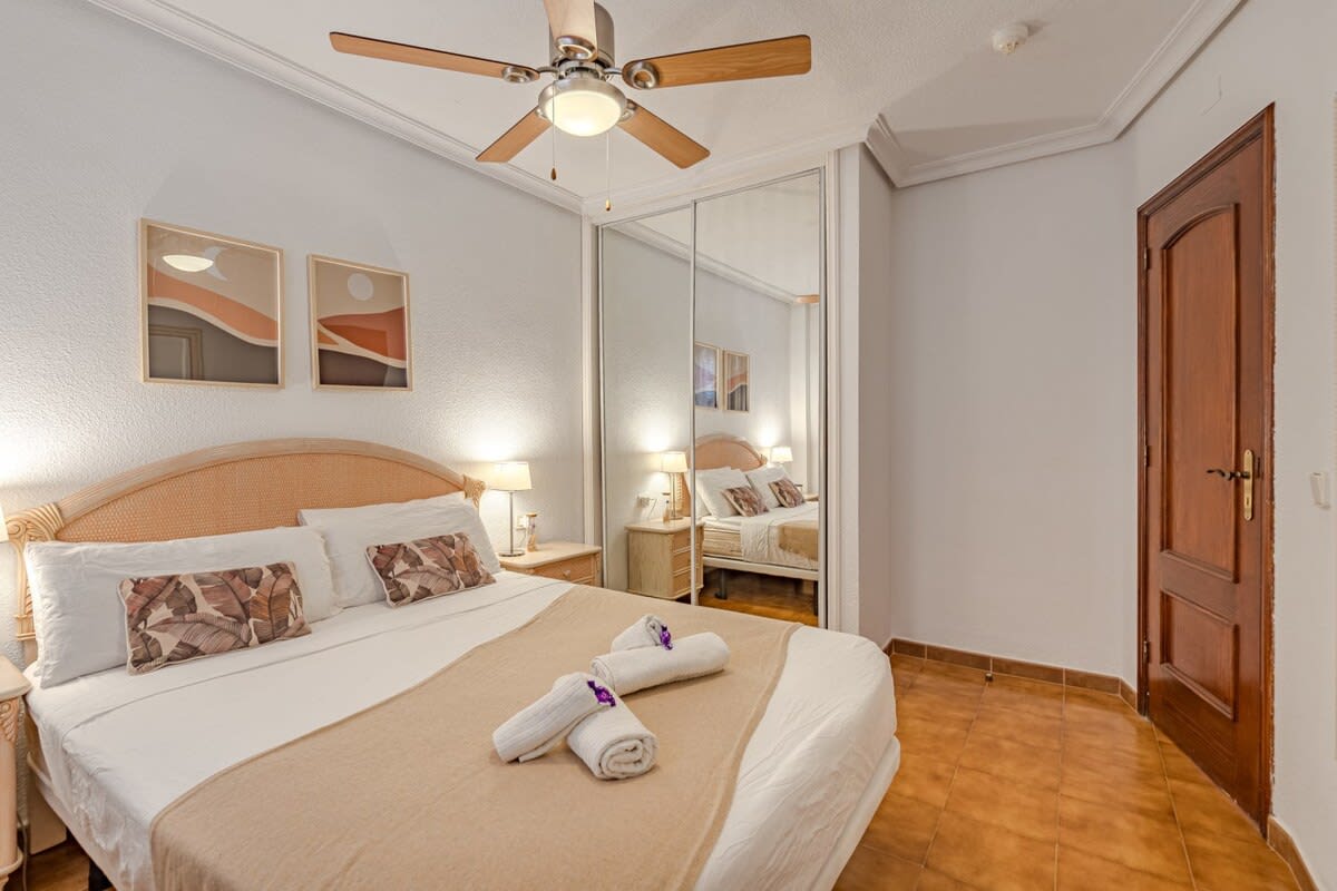 Bedroom with Queen-Bed, Wardrobe, Ceiling Fan & Pool View