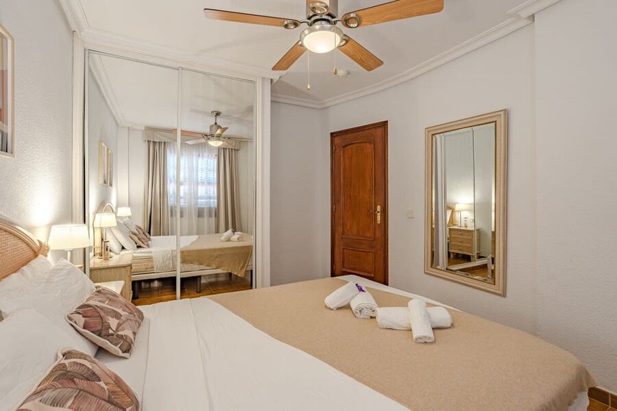 Bedroom with Queen-Bed, Wardrobe, Ceiling Fan & Pool View