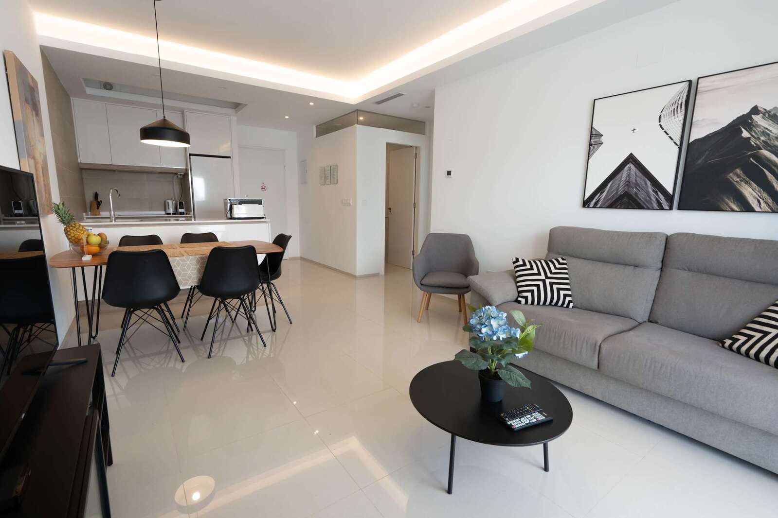 Living Room with Fully Equipped Kitchen, Dining Table, Sofa and TV