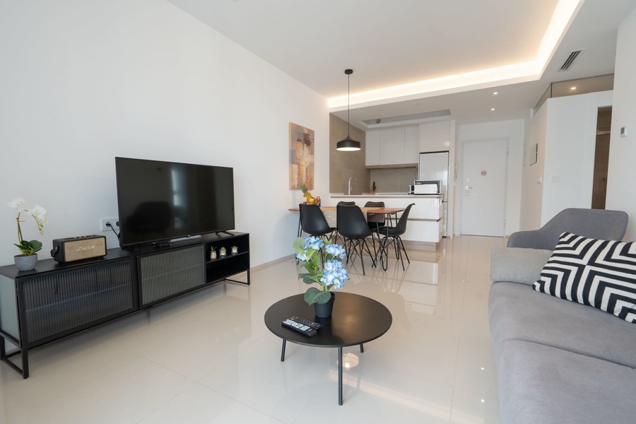 Living Room with Fully Equipped Kitchen, Dining Table, Sofa and TV