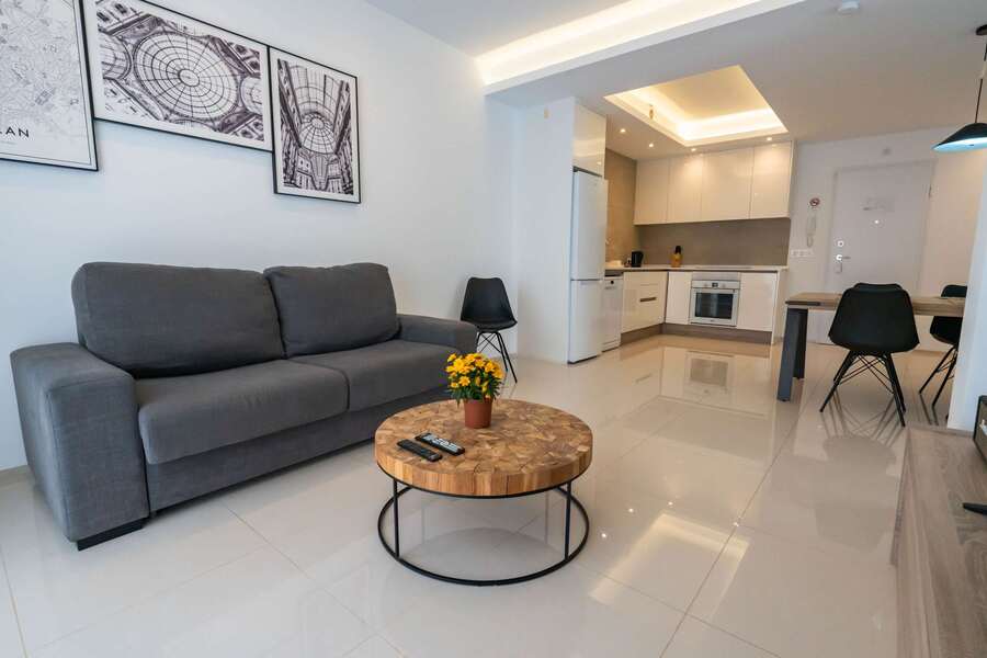 Living Room with Fully Equipped Kitchen, Dining Table, Sofa and TV