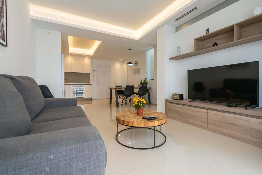 Living Room with Fully Equipped Kitchen, Dining Table, Sofa and TV