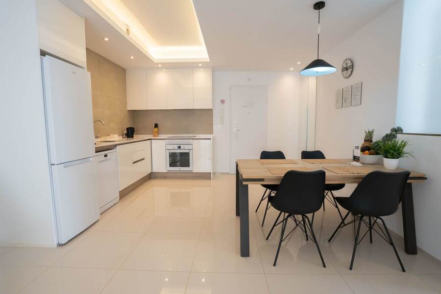 Kitchen with Dining Table, Oven, Stovetop, Microwave, Dishwasher, Fridge and Toaster