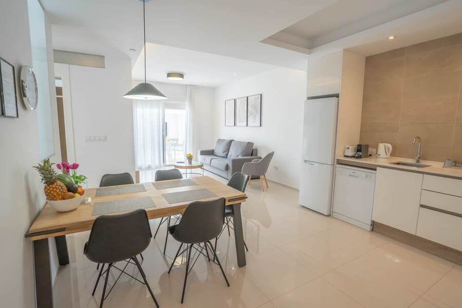 Kitchen with Dining Table, Oven, Stovetop, Microwave, Dishwasher, Fridge and Toaster