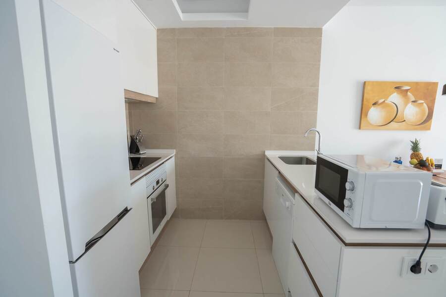 Kitchen with Dining Table, Oven, Stovetop, Microwave, Dishwasher, Fridge and Toaster