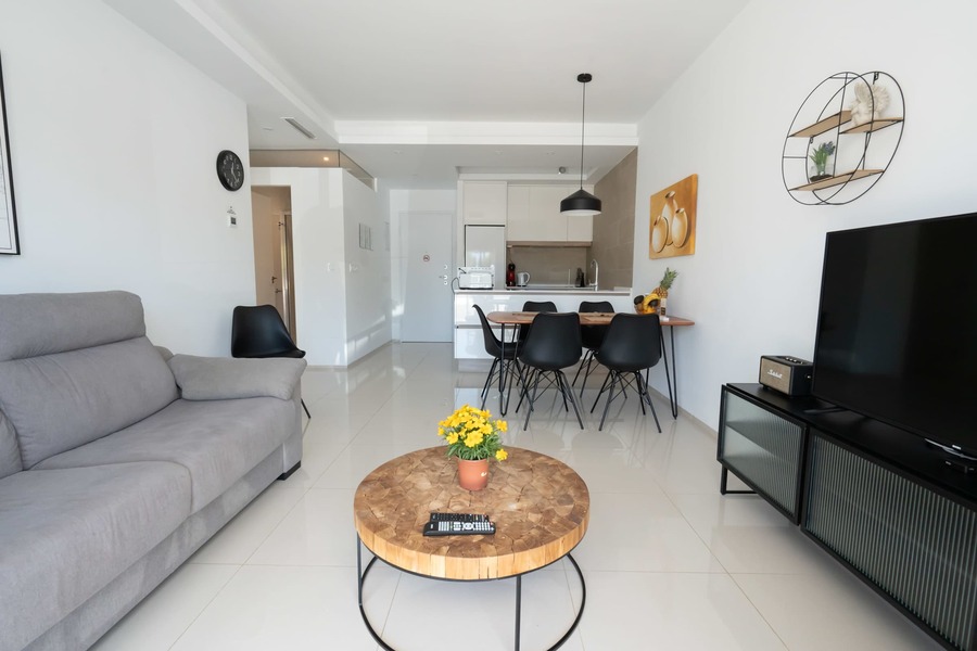 Living Room with Fully Equipped Kitchen, Dining Table, Sofa and TV