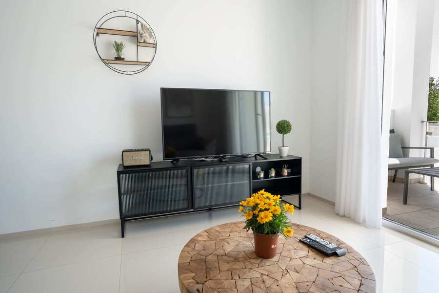 Living Room with Fully Equipped Kitchen, Dining Table, Sofa and TV