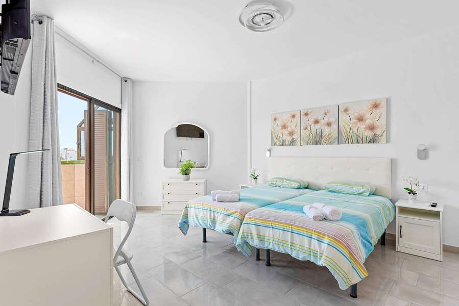 Bedroom with two Single Beds, Desk, Flatscreen TV, Wardrobe and Balcony Access