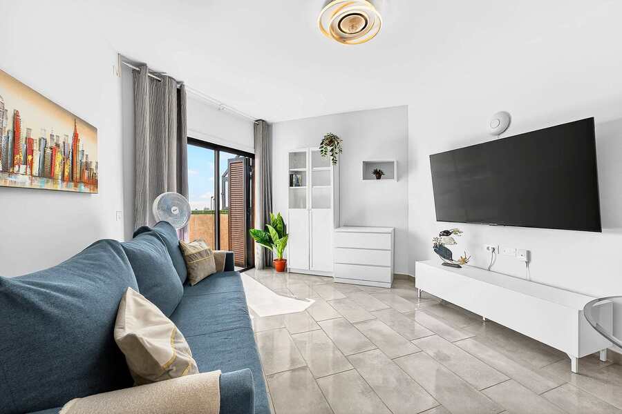 Livingroom with Dining Table, Sofa Bed, Flatscreen TV, and Balcony View