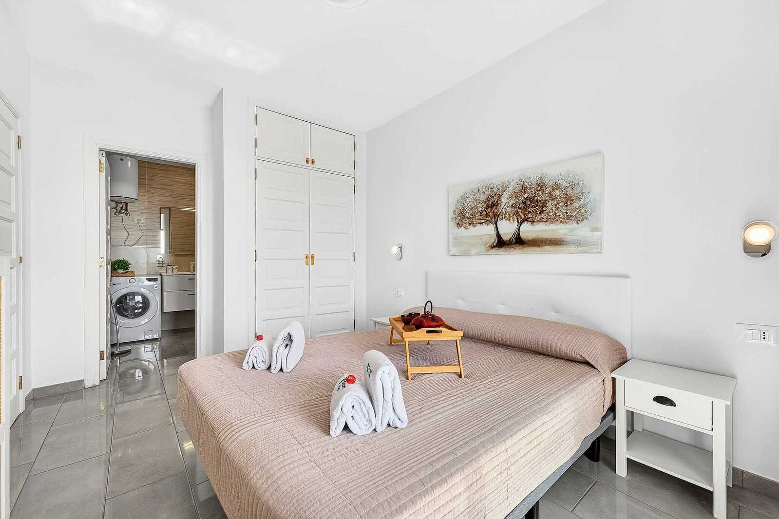 Bedroom with Queen Bed, Flatscreen TV, Wardrobe and Balcony Access