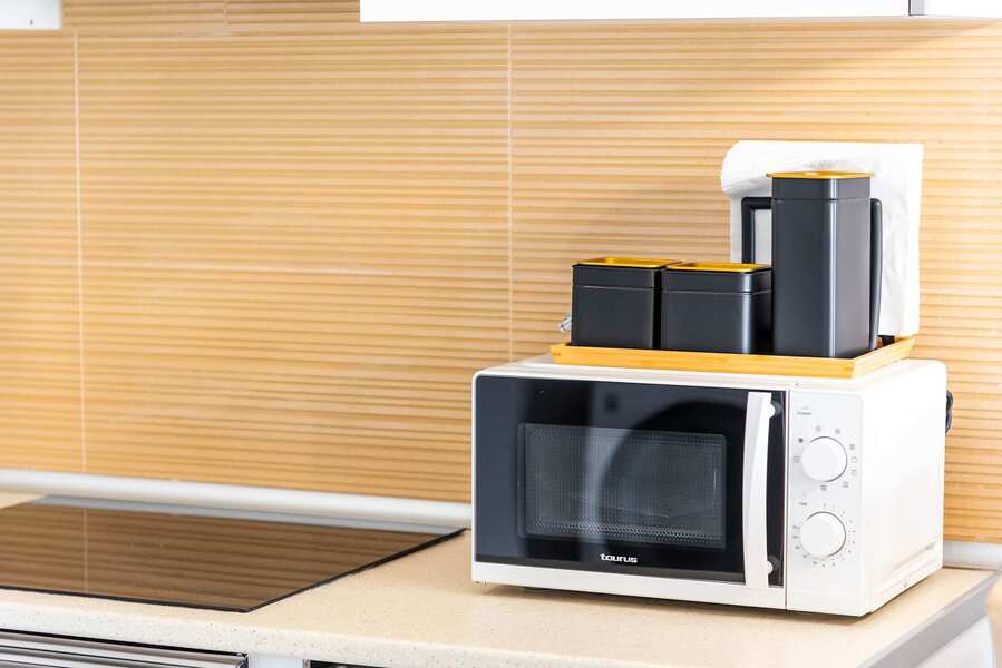 Fully Equipped Kitchen with Stovetop, Oven, Coffee Maker, Microwave & Fridge
