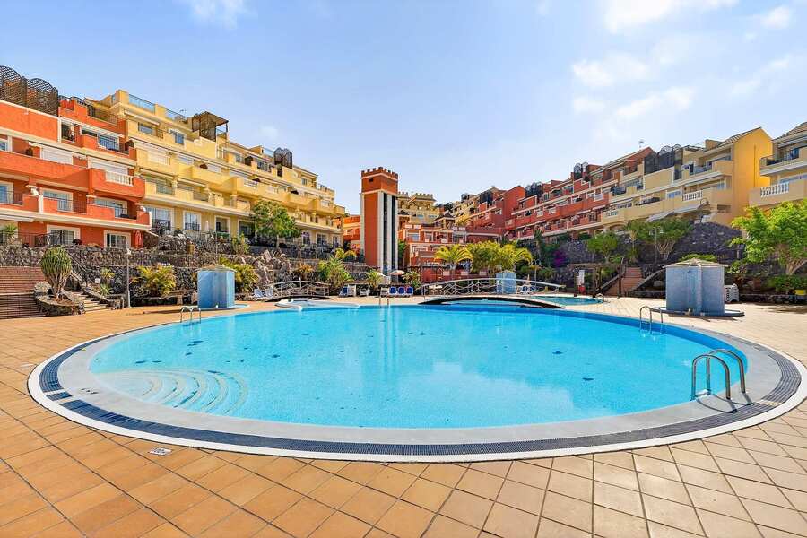Heated Communal Swimming Pool Surrounded by Spacious Sunbathing Areas