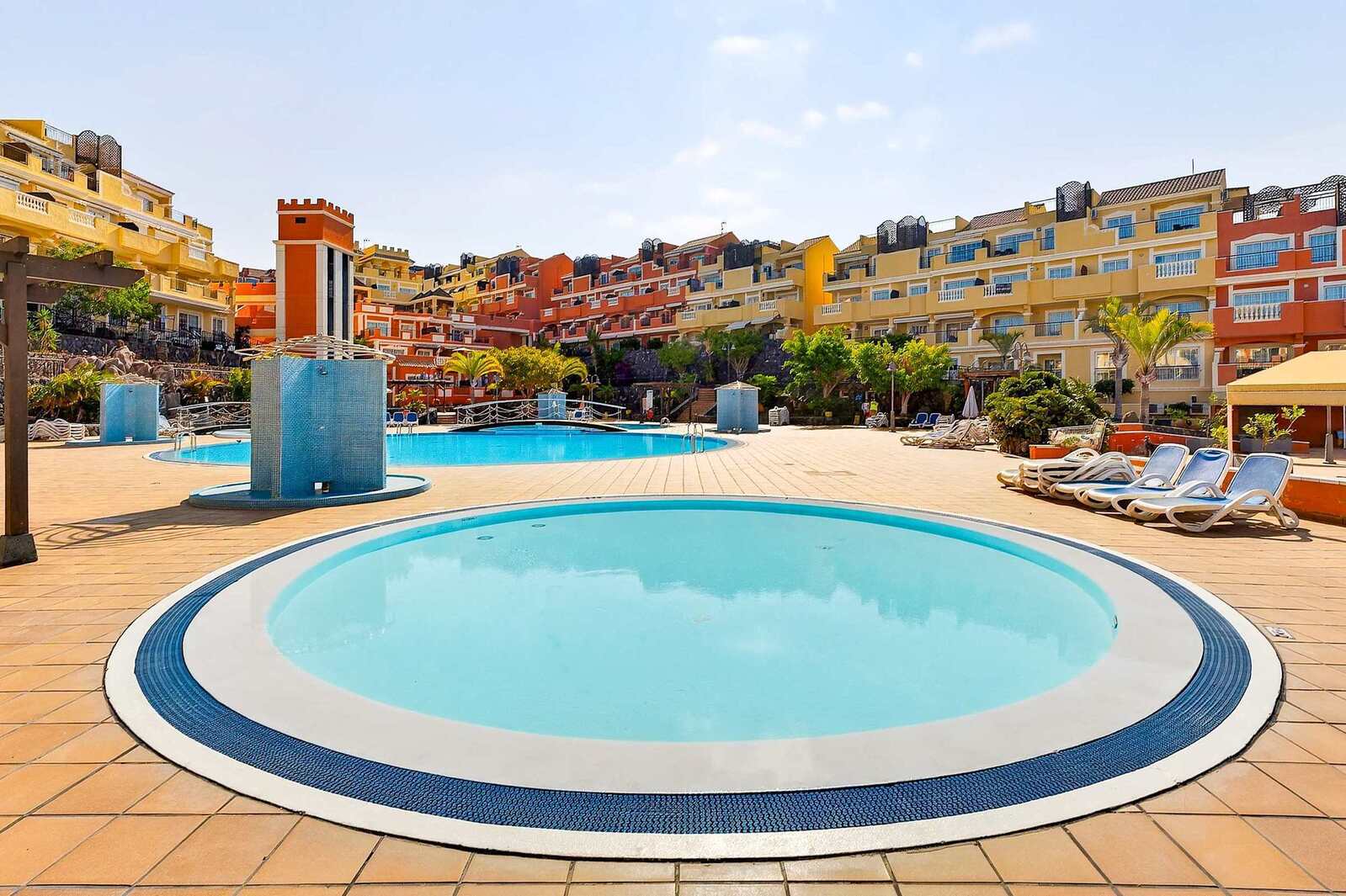 Heated Communal Swimming Pool Surrounded by Spacious Sunbathing Areas