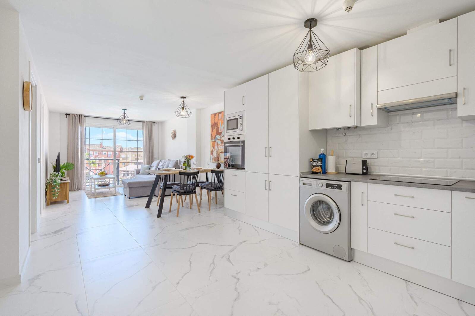 Kitchen with Stovetop, Oven, Fridge, Microwave, Dishwasher, Washing Machine, Coffee Maker, Electric Kettle and Toaster