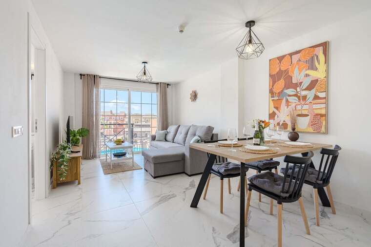 Living Room with TV, Sofa Bed, Dining Table, Coffee Table and Pool View