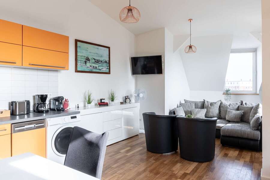 Open Kitchen & Living Area with Sofa-Bed, Armchairs & TV