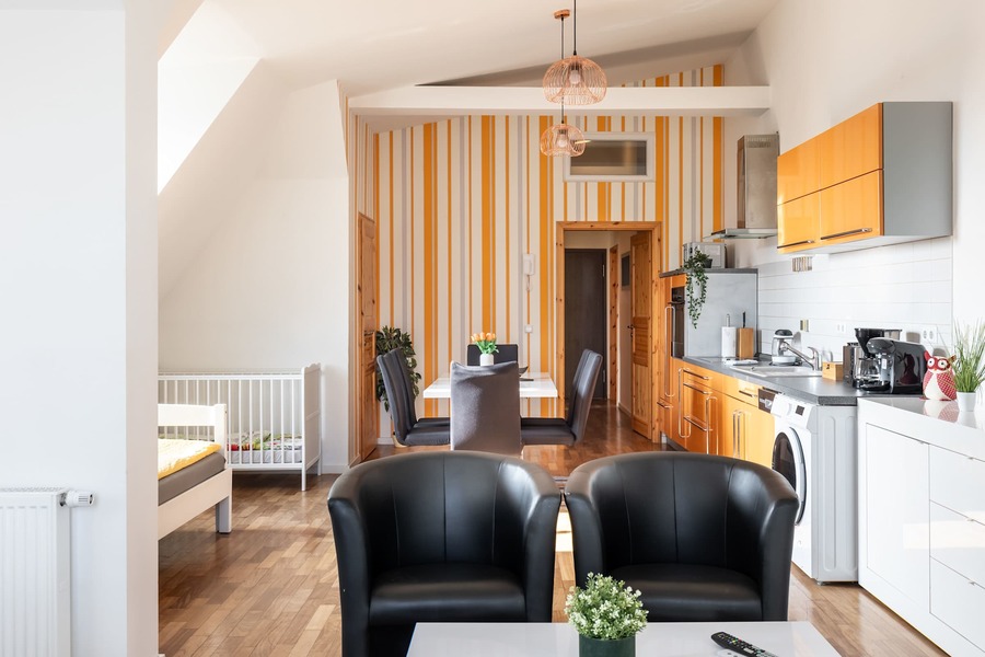 Open Kitchen & Living Area with Armchairs & Dining Table