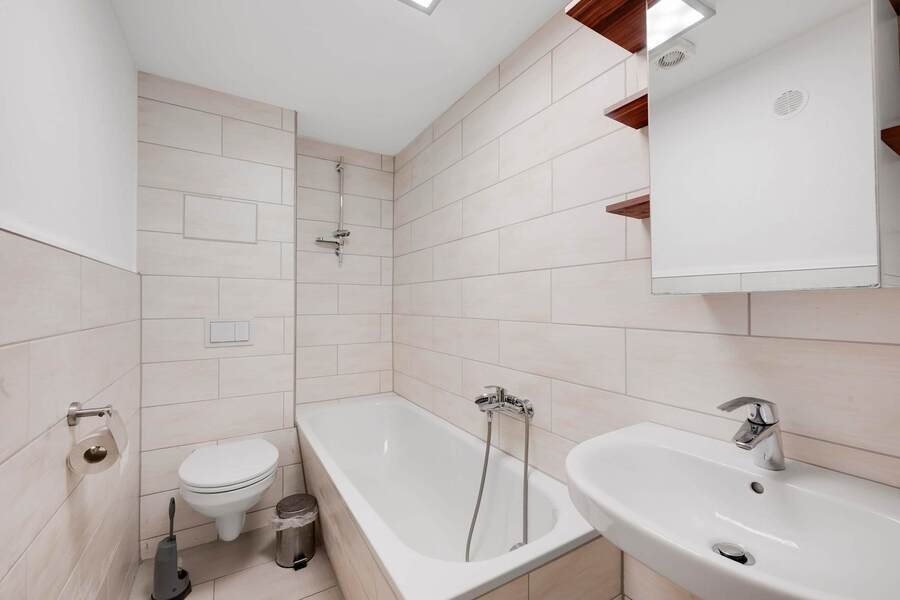 Modern Bathroom with Tub, Shower, and fresh Neutral Tiles.
