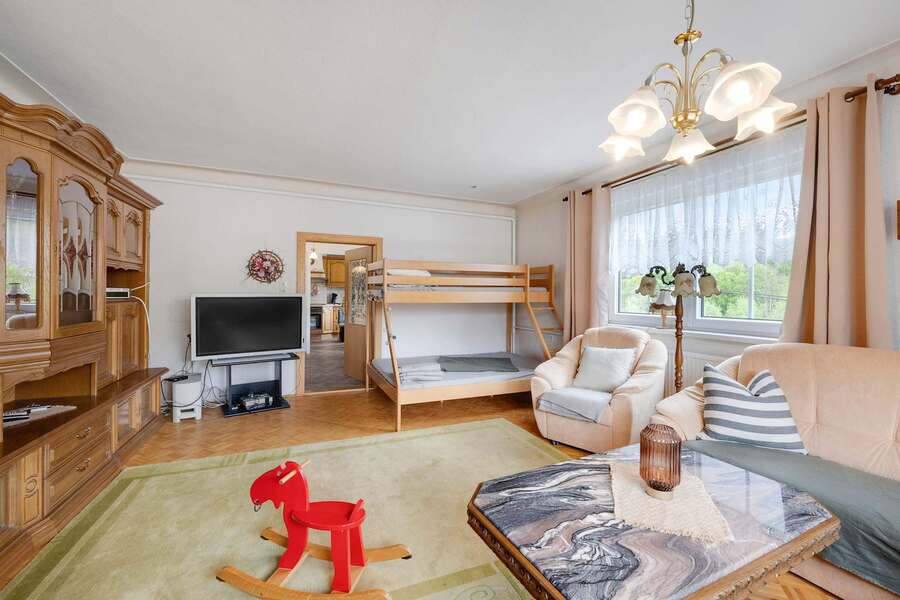 Spacious Lounge with Comfy Seating, TV, and plenty of Natural Light.