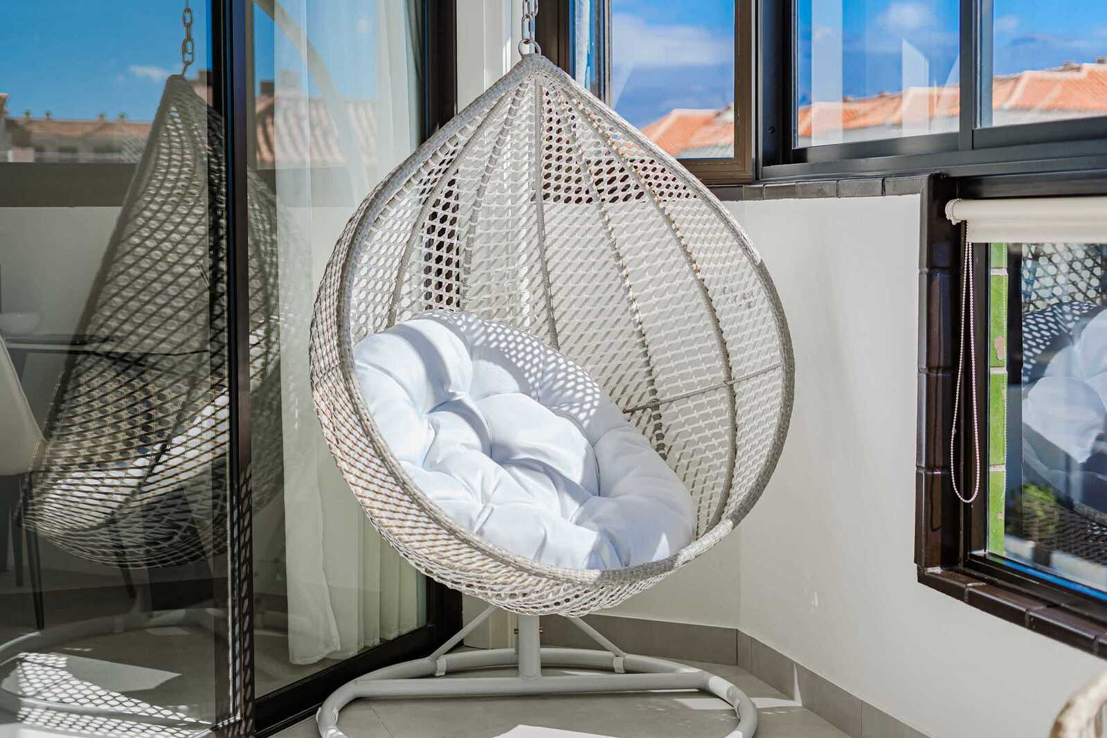 Stylish Hanging Egg Chair with Plush Cushioning and Ocean View — A Peaceful Spot to Unwind in Comfort