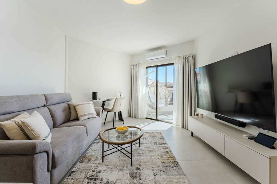 Bright Oceanfront Living Room with Designer Sofa, Oversized Flatscreen TV, Apple TV, Sonos Sound System & Elegant Workspace
