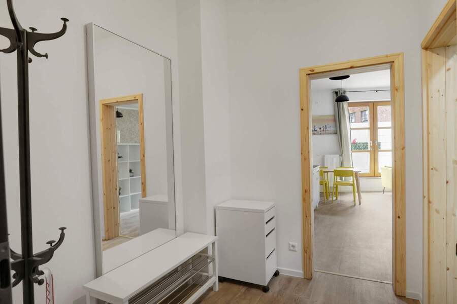 Entryway with mirror | Functional hallway space with coat rack and bench