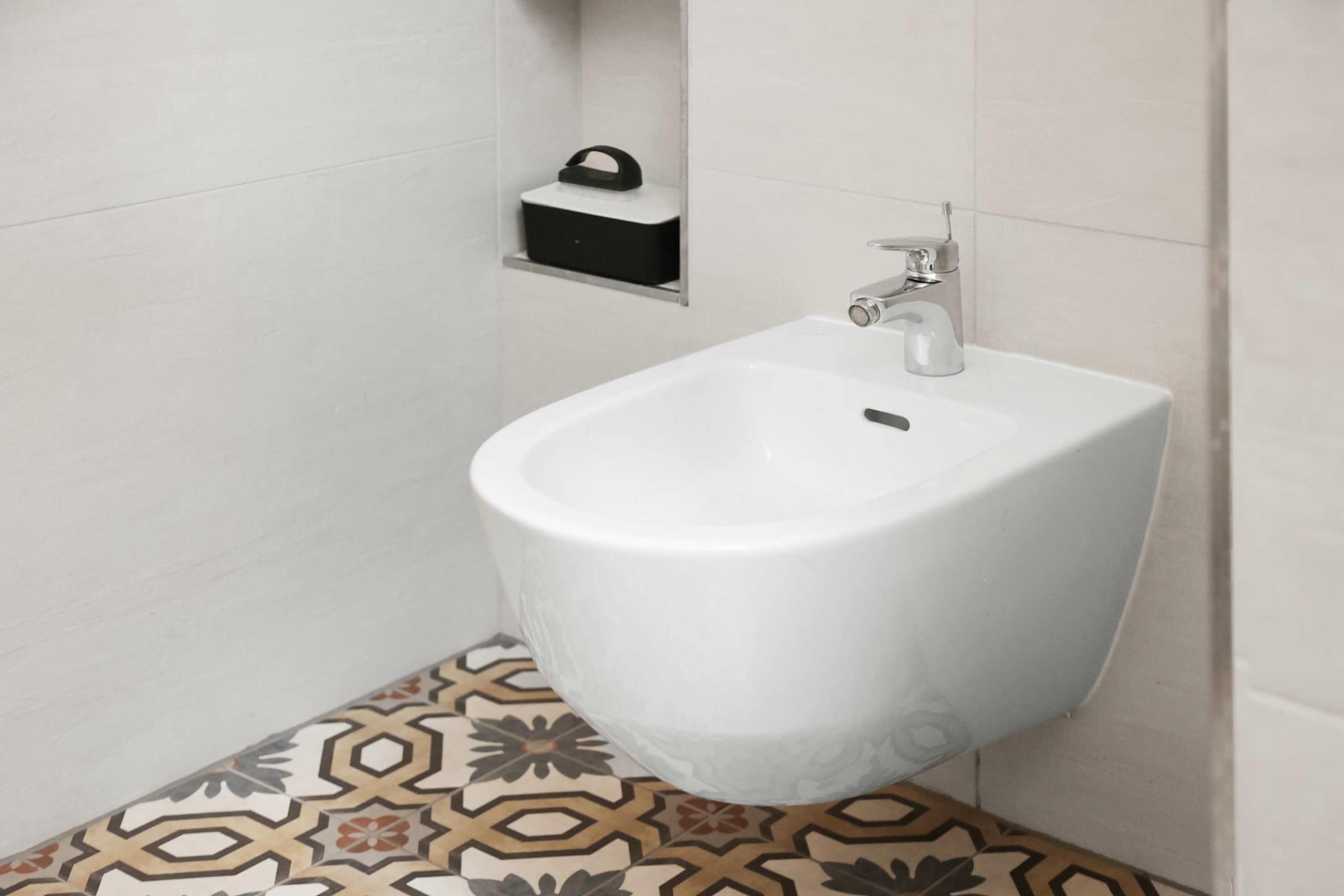 Modern Wall-Mounted Bidet | Stylish Comfort with Patterned Tile Accent