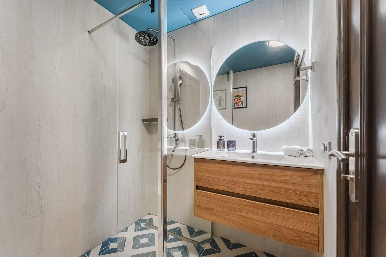 Spa-Inspired Bathroom with Rainfall Shower — Freshly Renovated with Backlit Mirror, Sleek Fixtures & Eye-Catching Geometric Flooring