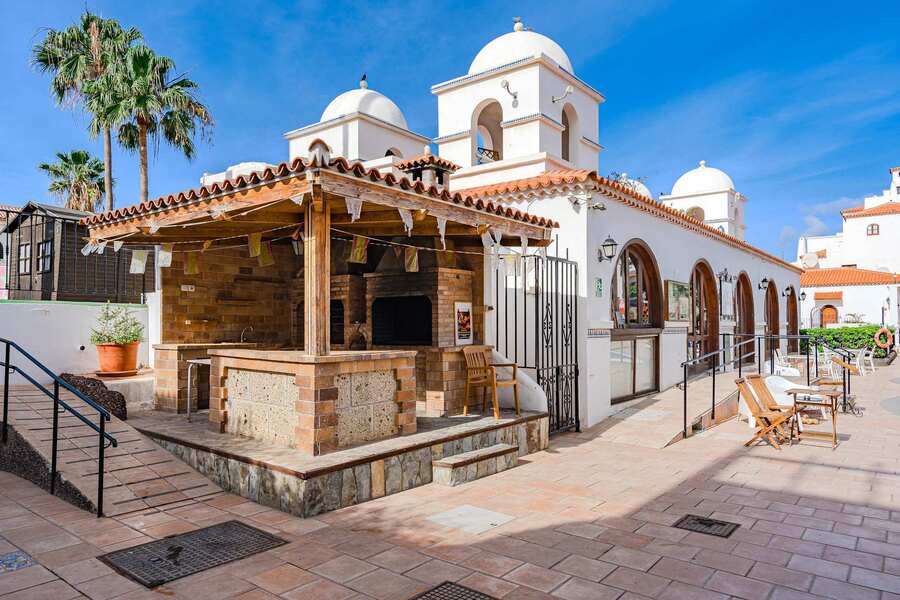 Charming Resort Architecture with Island Character — Whitewashed Domes, Arched Windows & Peaceful Palm-Studded Paths