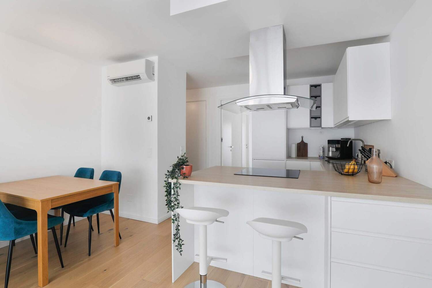 Open Kitchen with Island Seating, Air Conditioning, and Natural Light