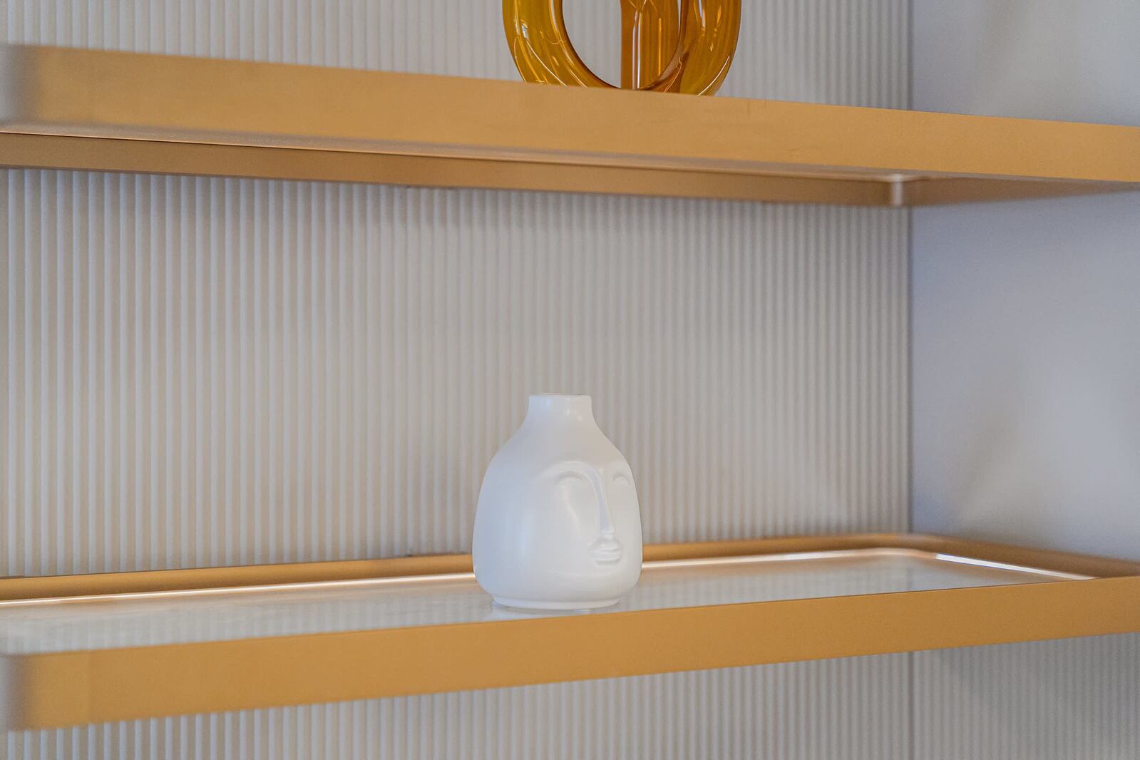 Minimalist White Vase on Golden Shelves – A Stylish Touch of Serenity