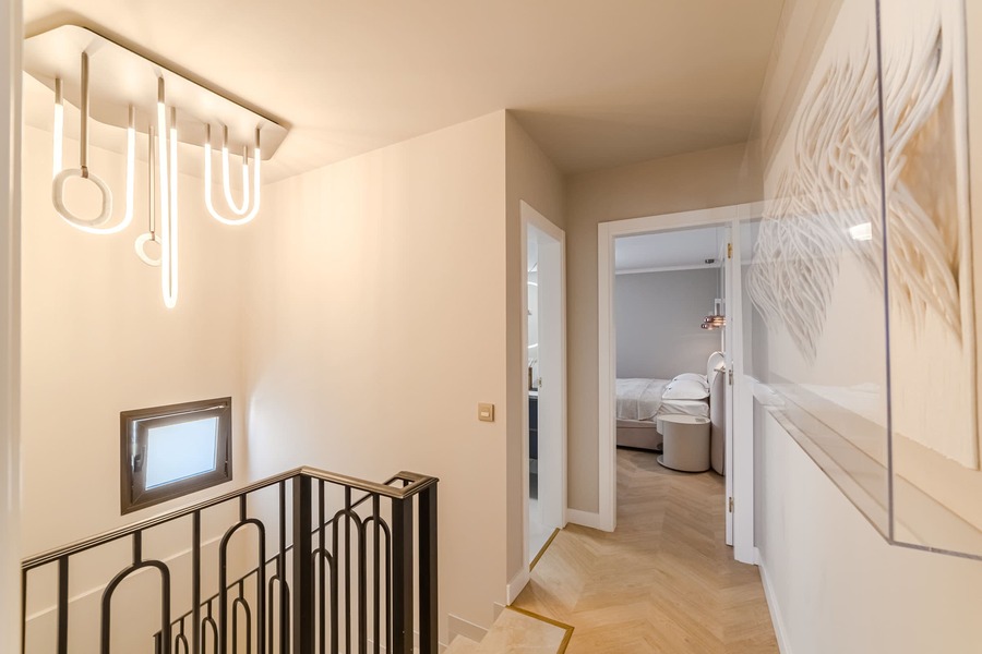 Modern Hallway Charm – Warm Lighting & Refined Design Leading Into Your Retreat