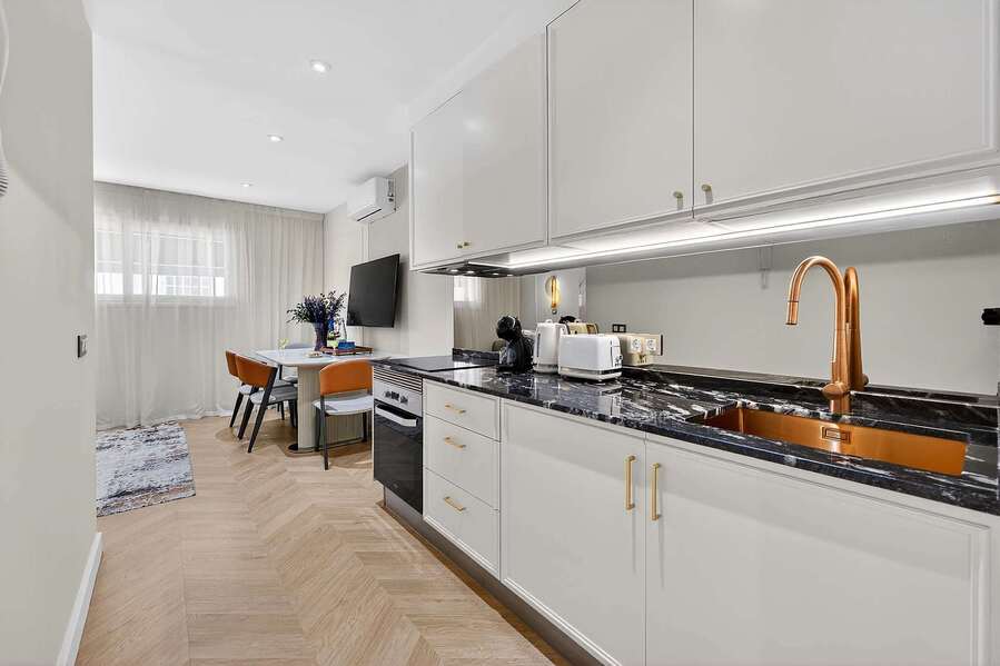 Sleek Marble Kitchen and Designer Fixtures – Cook and Dine in Style with Gold Accents and Luxe Appliances