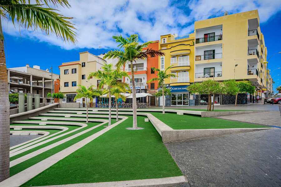 Colorful Urban Square – Bold Architecture Surrounding a Modern Green Plaza