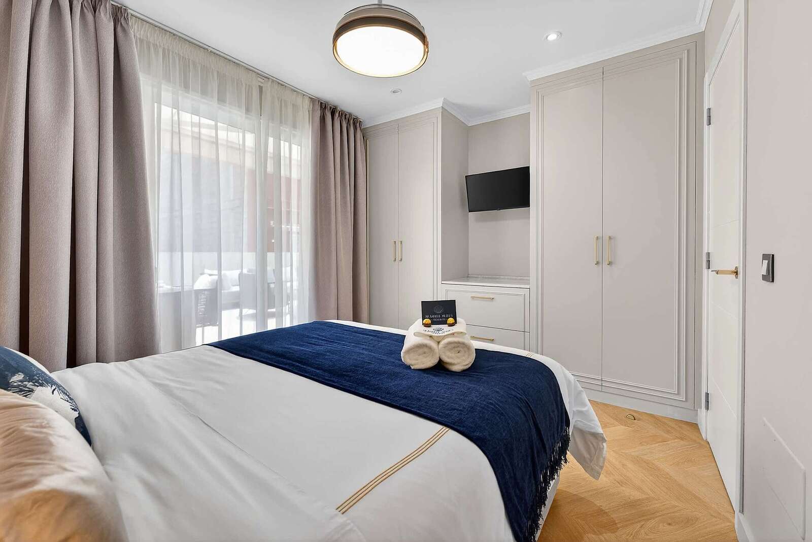 Tranquil Second Bedroom with Sea-Inspired Tones — Wake Refreshed in a Coastal Retreat with Soft Drapes and Plush Bedding