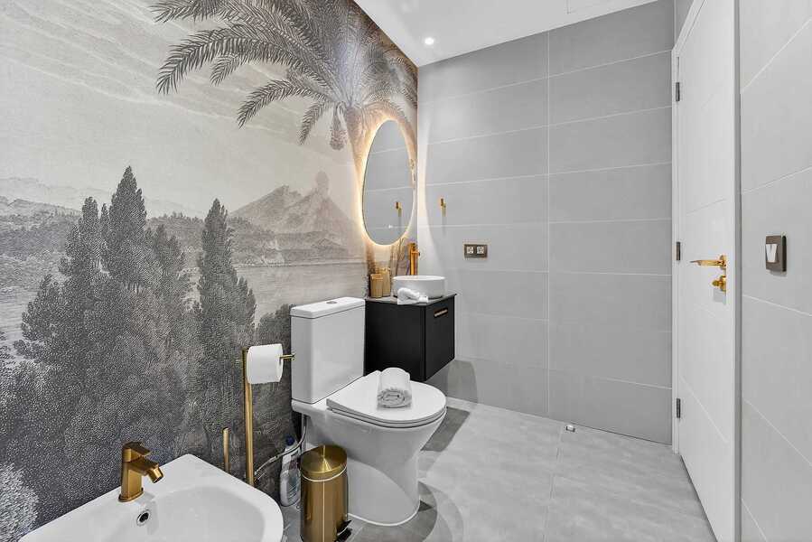 Spa-Inspired Bathroom with Scenic Mural and Gold Accents — Refresh in a Walk-In Rain Shower Framed by Mediterranean Elegance