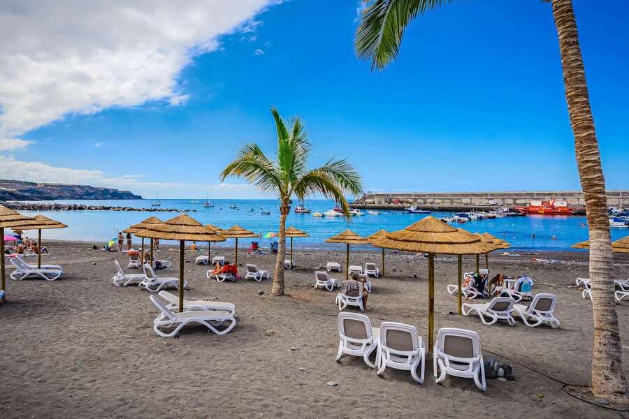 Sun-Drenched Shores – Relax Under Straw Parasols with Ocean Views