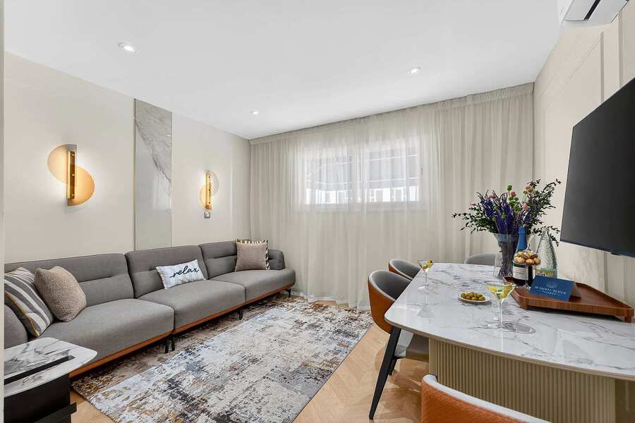 Elegant Open-Concept Living and Dining Area — Relax in Contemporary Comfort with a Designer Sofa, Smart TV and Ocean Breeze Ambience
