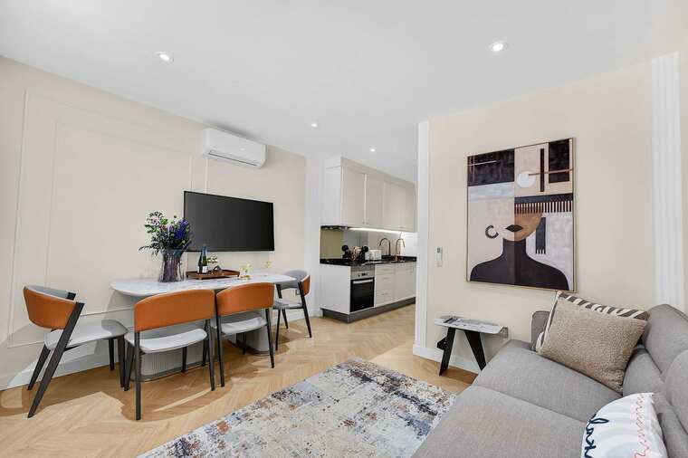 Elegant Open-Concept Living and Dining Area — Relax in Contemporary Comfort with a Designer Sofa, Smart TV and Ocean Breeze Ambience