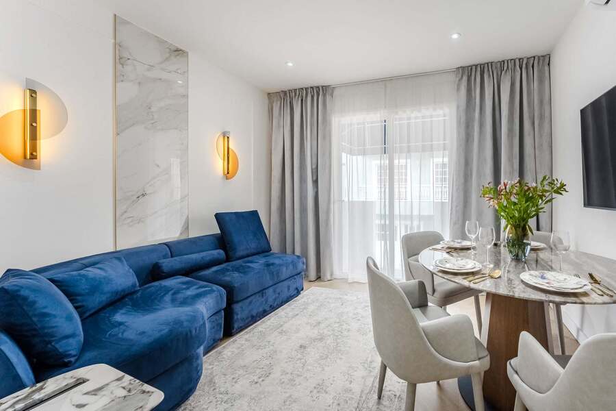 Elegant open-plan Living Room with Modern Velvet Sofa, Soft Lighting & Smart TV – ideal for Stylish Evenings in Playa San Juan