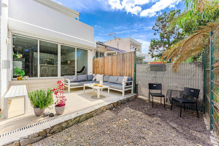 Ground Floor Terrace with Lounge Sofa, Garden Wall and Shade Awning – An Inviting Outdoor Nook for Morning Coffee or Aperitivo