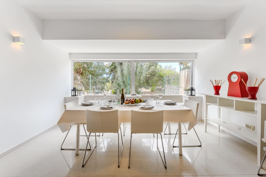 Bright Dining Area with Floor-to-Ceiling Windows – Garden Views, Contemporary Decor, and Table Set for Shared Moments