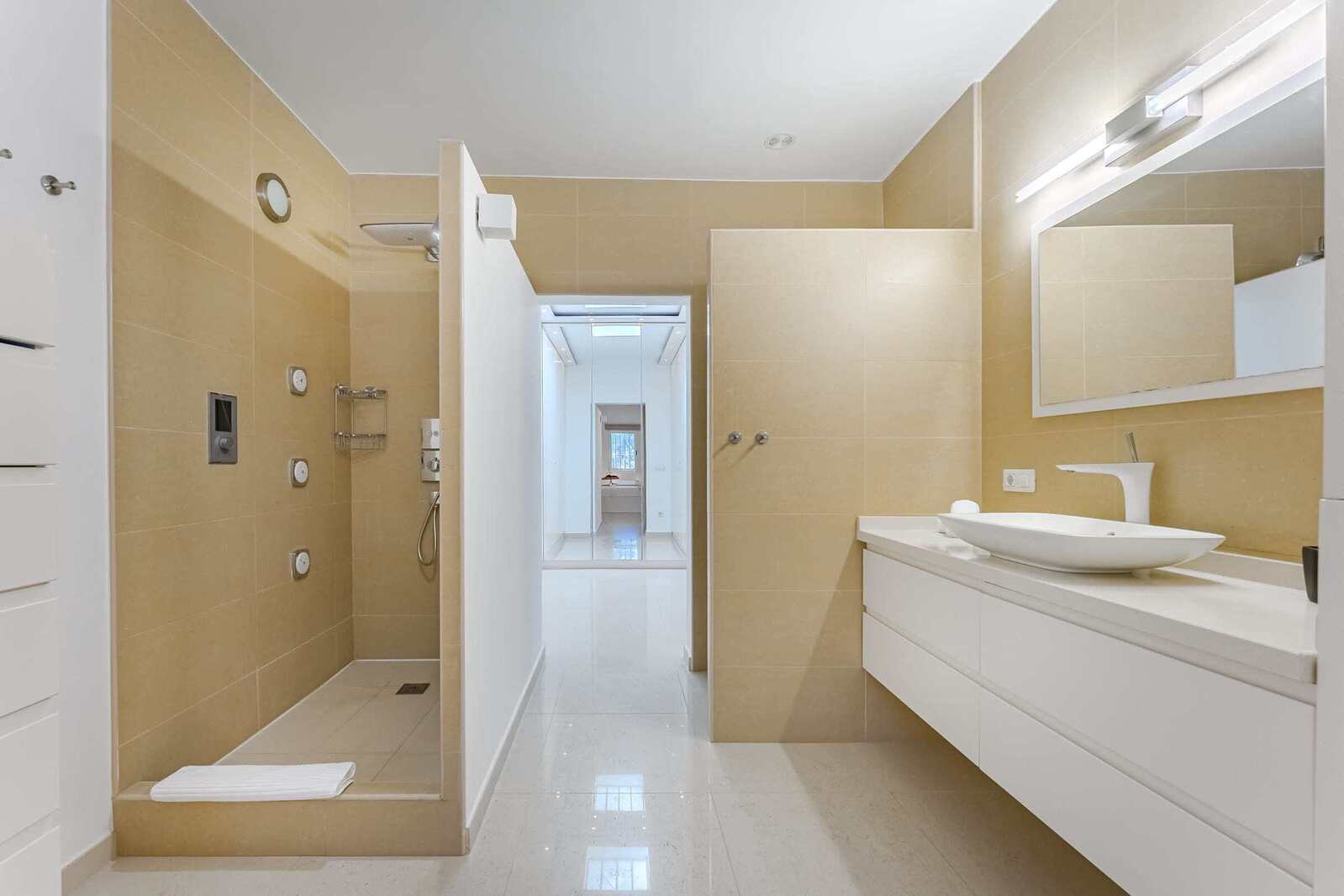 Ensuite Bathroom with Rain Shower, Natural Stone Tiles and Backlit Vanity – Your Private Wellness Zone
