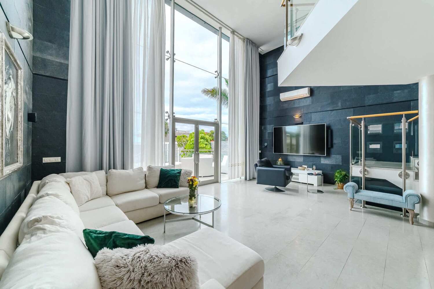 Spacious Designer Living Room with Soaring Ceilings - Unwind in Style with Smart TV, Plush Sofa, and Indoor-Outdoor Flow