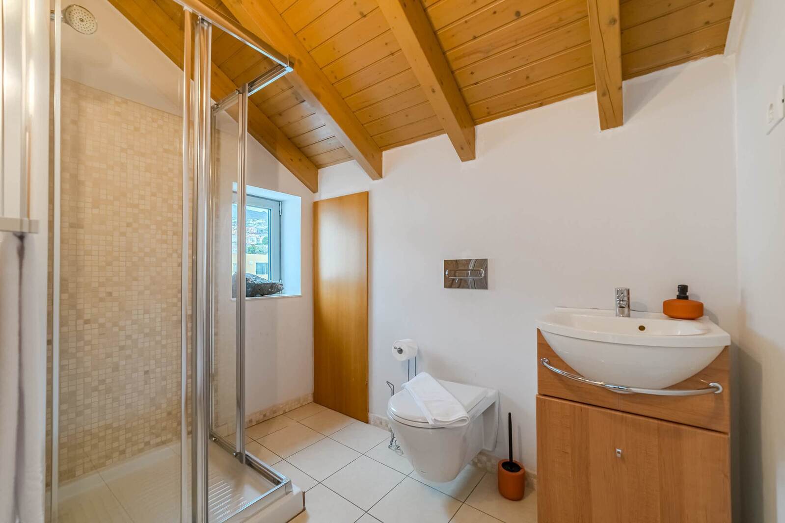 Charming Top-Floor Bathroom with Skylight - Rustic Wooden Ceilings and a Fresh Spa-Like Atmosphere