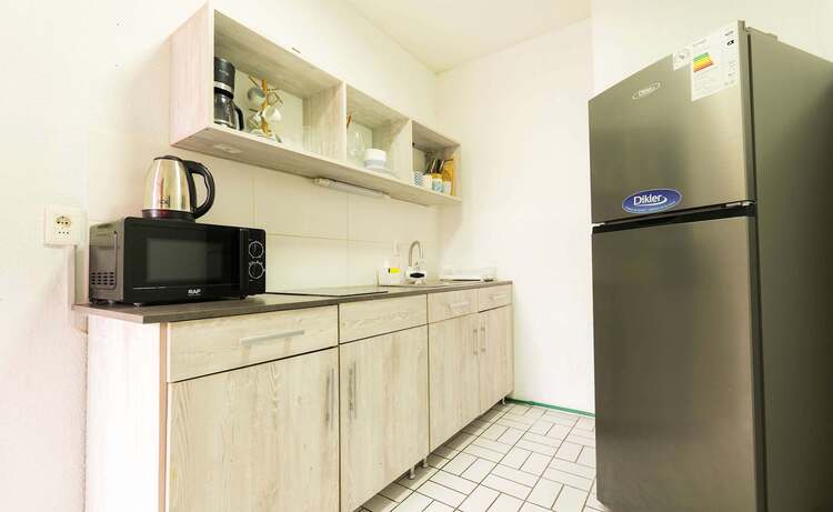 Galley Kitchen with Full Fridge