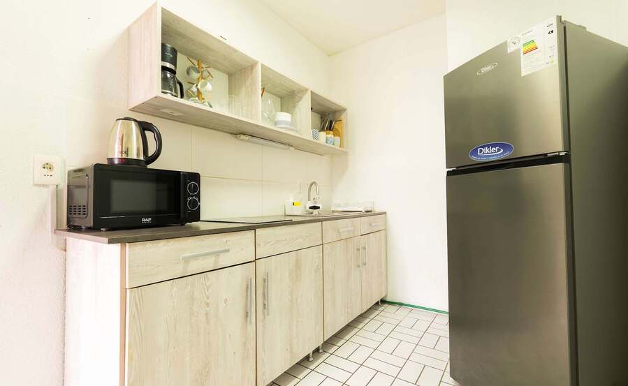 Galley Kitchen with Full Fridge