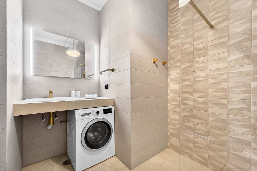 The Golden Luxury En-Suite Bathroom with Shower, WC, Sink, Washing Machine and all Amenities