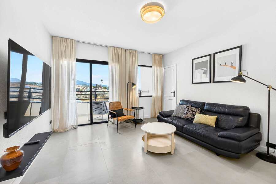 Modern Living Room with Smart TV, Balcony Access & Scenic Views